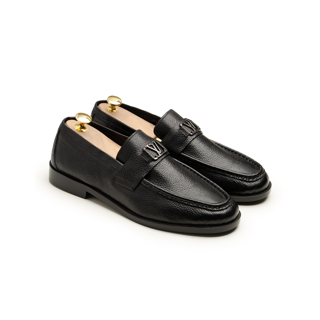 Pair of black loafers on a white background